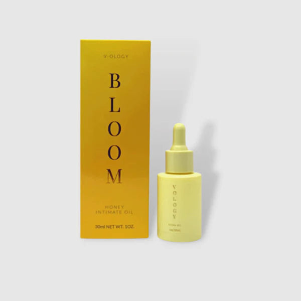 A bottle of Bloom Honey Intimate Oil designed to help with bacterial vaginosis and yeast infection, next to a box.