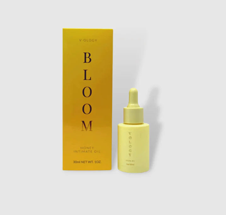 A bottle of V-OLOGY Bloom Honey Intimate Oil, a home remedy for bacterial vaginosis and vaginal odor, next to a box.