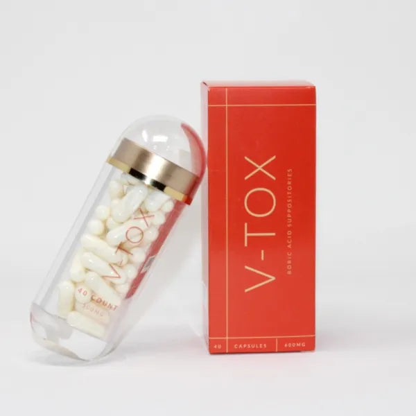 A bottle of V-OLOGY V-Tox Boric Acid Suppositories on a table next to a box.