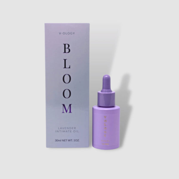 A bottle of V-OLOGY Bloom Lavender Intimate Oil next to a box provides a natural remedy for keeping your vagina smelling good and combating bacterial vaginosis (BV).